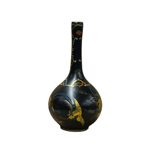 This elegant long-necked globular vase features a striking matte black finish, serving as a dramatic canvas for its...