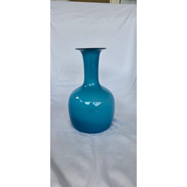 Stunning mid-century art glass vase by Kastrup-Holmegaard (Denmark). Featuring a rich teal/turquoise blue exterior paired...