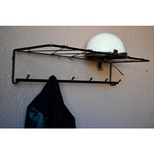 Here's a classic 1950s wall-mounted coat rack! Its black metal tube frame is both simple and stylish. At the top, a hat...