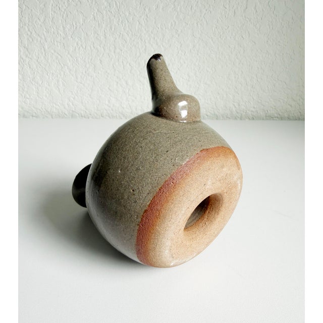 Mid-20th-century clay sake warmer, called a jikakanbin. Meant to be placed directly on the stove with the donut shape...