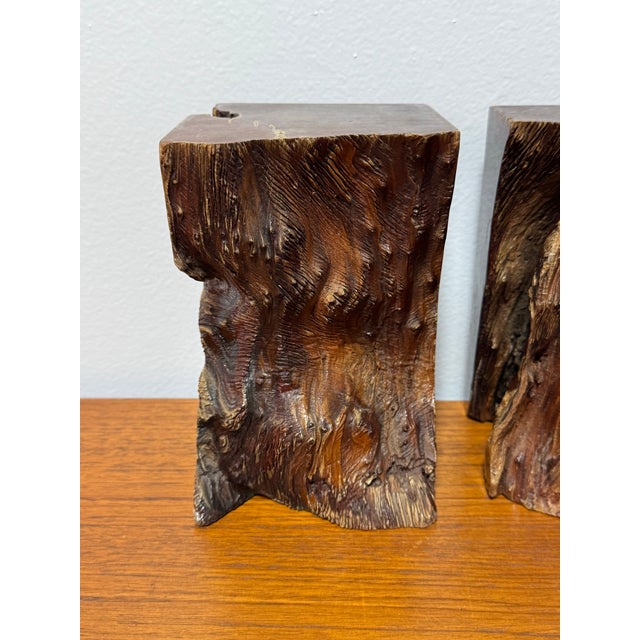 A striking pair of sculptural burl wood bookends with incredible natural movement and texture. Each piece is carved from...