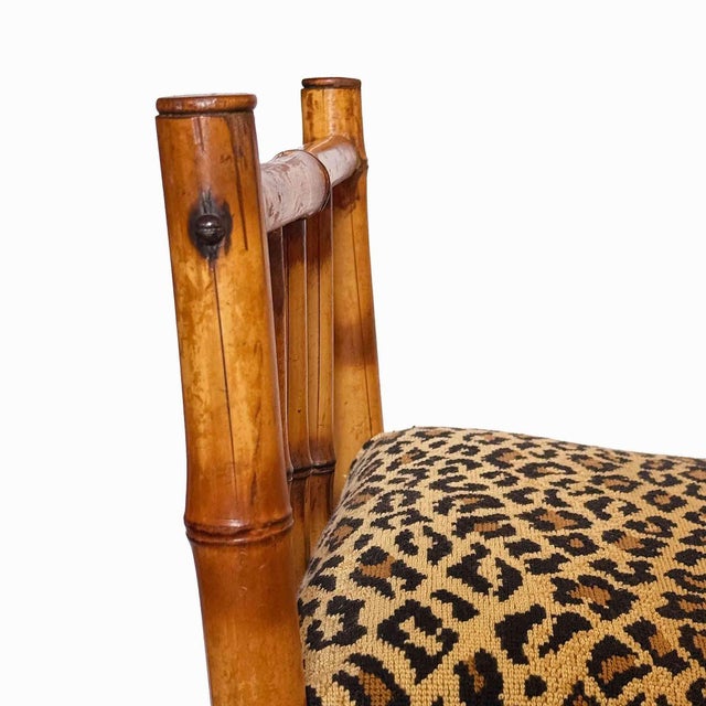 Vintage Chinoiserie bamboo bench with upholstered leopard print seat. Bamboo has splits in areas (please see photos)....