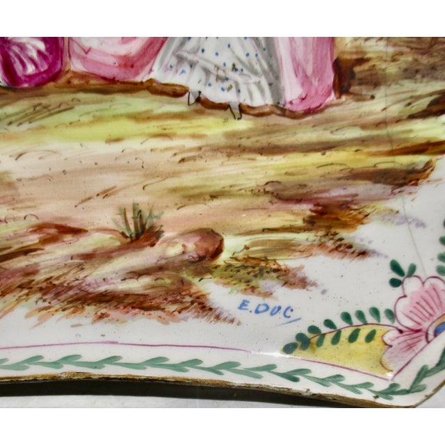 French Faience shallow tray. Raised on a rope turned base and hand-painted courting scene in the Rococo manner. Hand-...