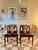 A beautiful set of 4 mid century modern dining chairs in teak with black faux leather seats, designed by Elliots of...