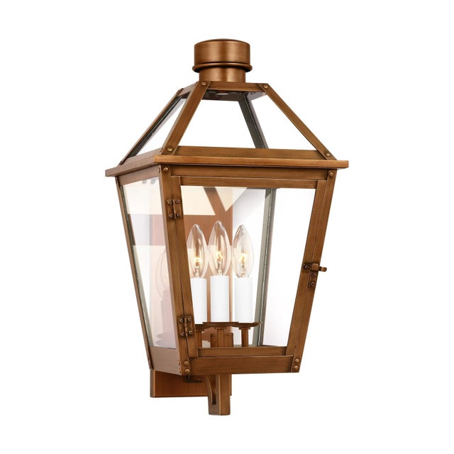 The Hyannis three light outdoor wall fixture in natural copper by Chapman & Myers has a classic copper lantern profile...
