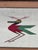 This beautiful hand-woven flat-weave wool textile features a stylized multicolored bird with geometric wings and crest. It...