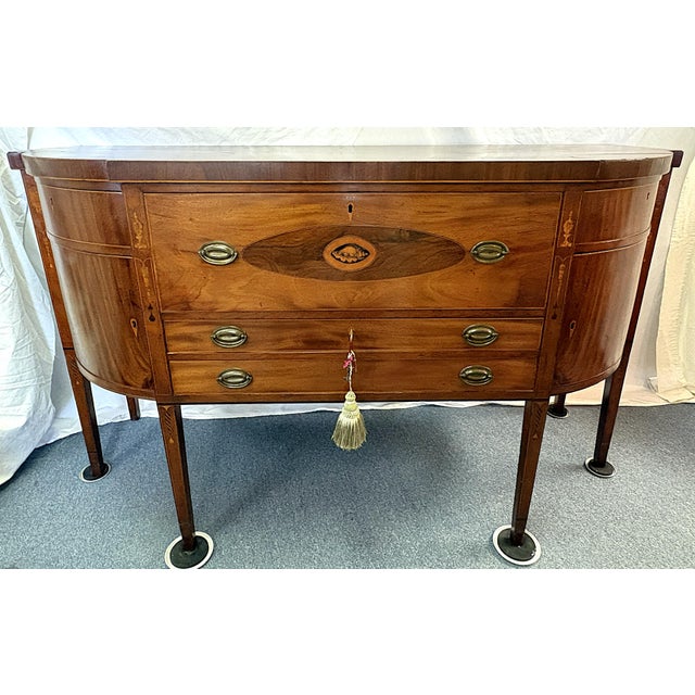 Remarkable piece of craftmanship from the 19th century. This Sheraton style sideboard is specially designed as a butler's...