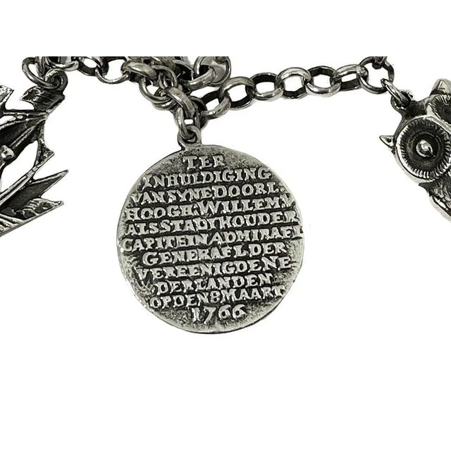 A Dutch mid-20th century silver large charms bracelet. A silver charm bracelet of silver, consisting of 835/1000 purity of...