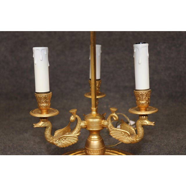 Illuminate your space with timeless French elegance using this exquisite gilt bronze swan bouillotte lamp, a sophisticated...