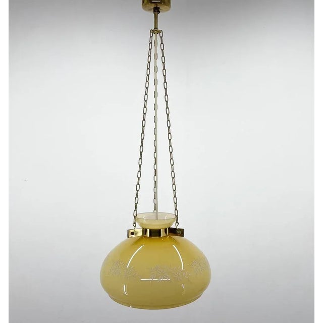Beautiful mid-century pendant light, made of glass with painted flower pattern on brass chains. Bulbs: 1 x E25-E27. Up to...