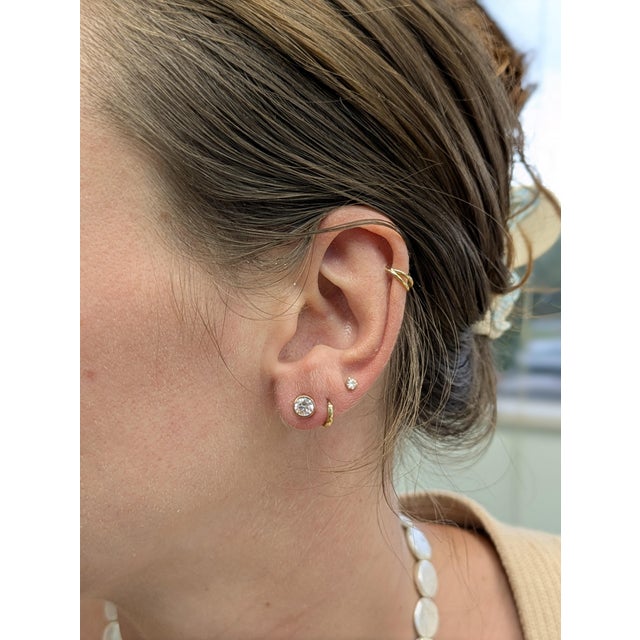 These lab-grown diamond studs redefine minimalist glamour—crafted in solid 14k rose gold, the bezel setting hugs each 5mm...