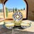 A coordinated set of four L.A.B.O.R. Deruta cups and matching saucers, hand painted in Deruta, Umbria, Italy, during the...