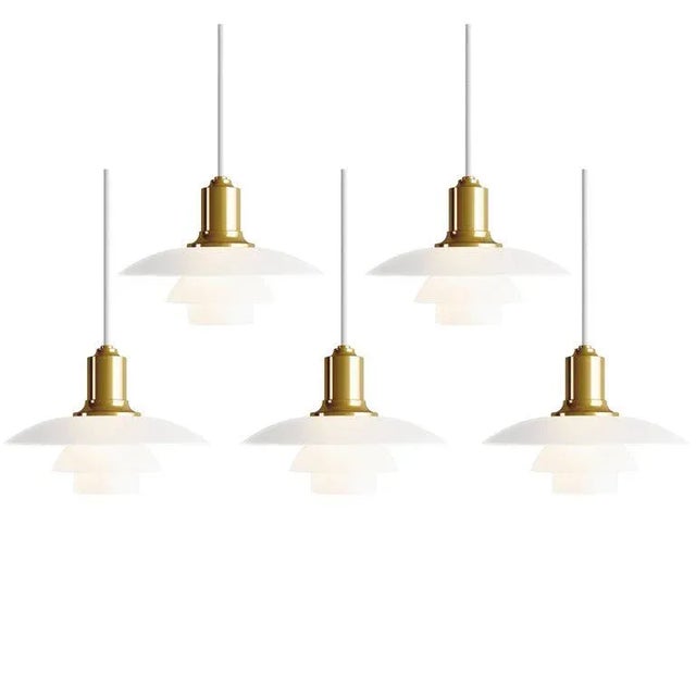 Poul Henningsen PH 2/1 brass and glass pendants for Louis Poulsen. Executed in white opal glass and a brass, chrome or...