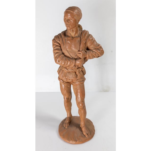 We are selling this interesting Mid-Century Terra Cotta or Redware Figure. The figure is stamped with copyright for Fred...