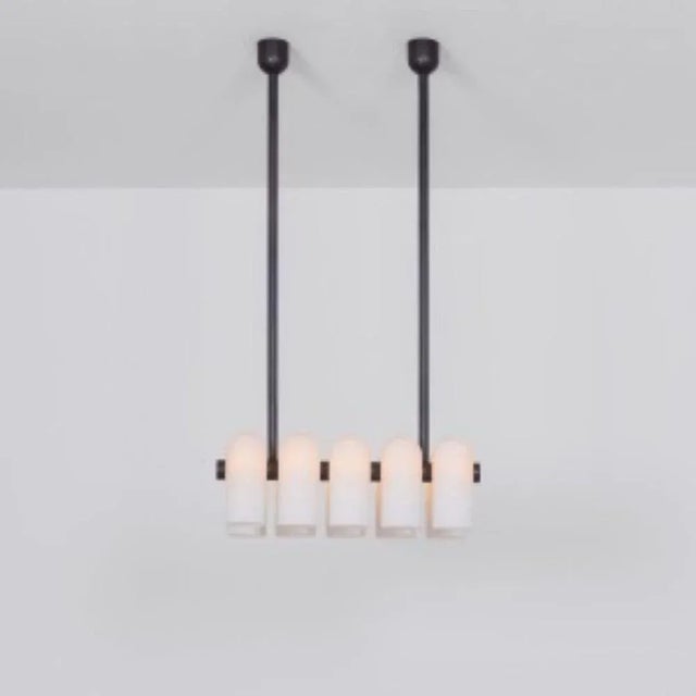 Odyssey linear sm black chandelier by schwung dimensions: w 114 x d 31 x h 132 cm materials: black gunmetal and frosted...
