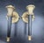 An exceptional and highly decorative pair of Neoclassical cast brass torch sconces, distinguished by their elegant...