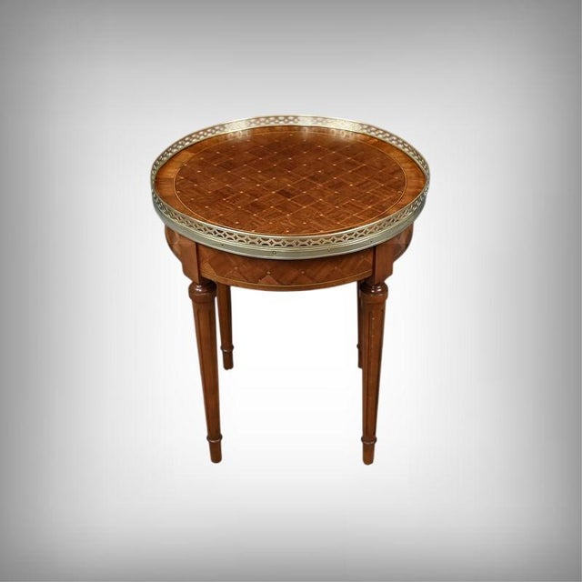 This exquisite Louis XVI style bouillotte table embodies neoclassical elegance in all its refinement. Crafted from...