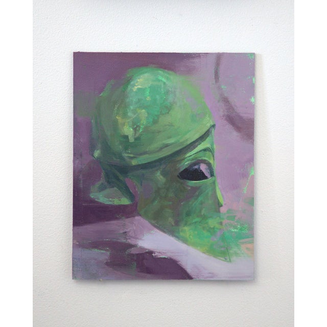 The artwork features a stylized, green-hued figure that evokes a sense of contemplation and introspection against a soft...