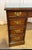 Vintage Sligh Mahogany Leather Top Partners Desk With Glass. The desk has 7 drawers with brass handles. It measures 30”Hx...