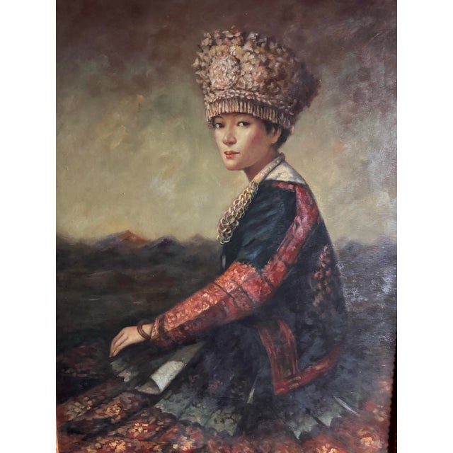 A striking original Chinese portrait oil painting depicting a woman in traditional ethnic dress, rendered with atmospheric...