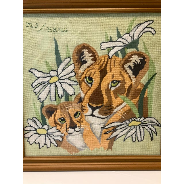 1970's Framed handmade needlepoint lioness and cub with daisies. Beautifully stitched including makers initials.