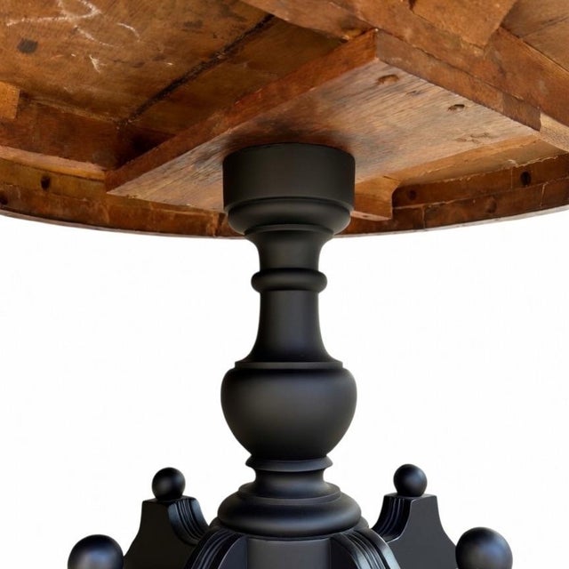 A distinctive pedestal parlor table featuring a beautifully turned central column, sculptural four-footed base, and...