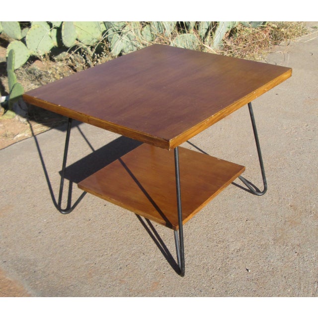 Vintage mid century modern wooden 2 tier table with metal hairpin legs. The table has 2 rectangular wooden levels...