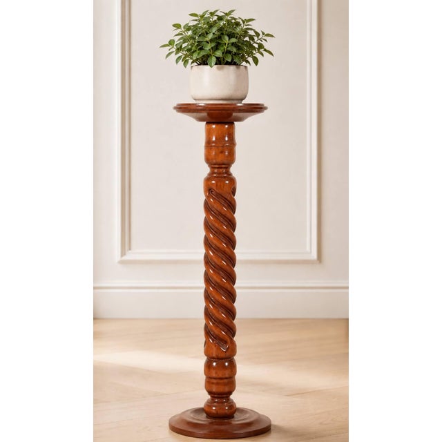 A classic mahogany pedestal stand featuring a beautifully turned barley twist column, round top, and circular base. The...