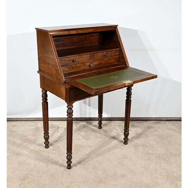 This solid mahogany slope office and mahogany veneer includes a lower part opening by a belt drawer. This drawer has a key...
