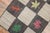 A handmade decorative American hooked rug from the middle of the 20th century with an assortment of leaves on a repetitive...