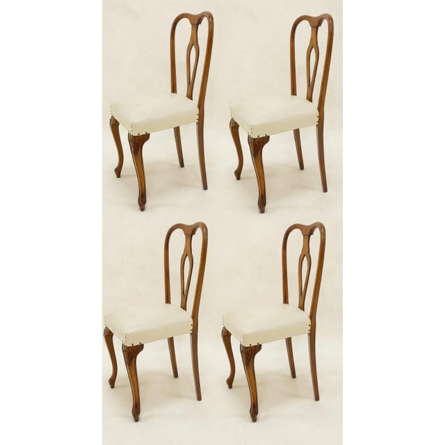 Set of Four Original Solid Walnut Chairs from the 1960s This refined set of four dining chairs from the 1960s represents...