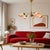 Vintage Mid-Century Modern five-light chandelier featuring brass arms, teak wood accents, and hand-painted opaline glass...
