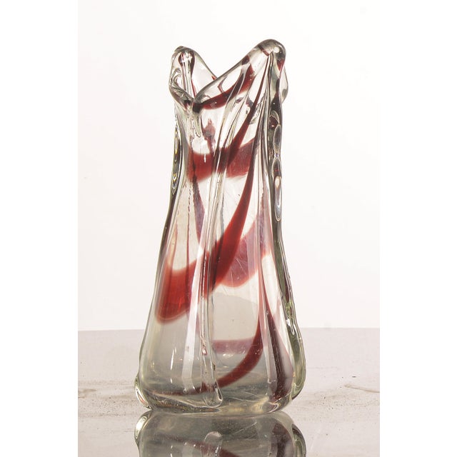 Red murano glass vase shaded, italy, 1980s with a tapered shape with apertua beak, made of clear glass with red streaks....