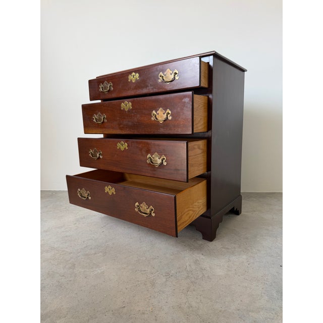 A timeless vintage Georgian Chippendale-style nightstand or bachelor’s chest, beautifully crafted from solid mahogany....