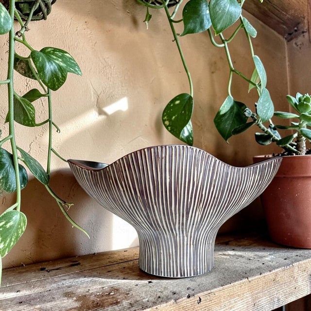 Elevate your home decor with our Organic Textured Ceramic Vase, featuring a unique striped detail that adds a touch of...