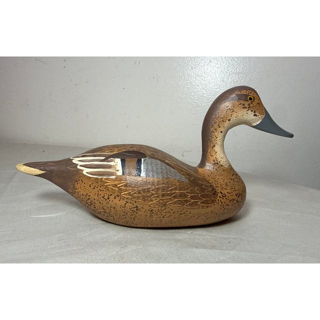 This vintage 1983 hand carved wood Clarence Bauer miniature duck decoy sculpture is a unique and collectible piece of art....