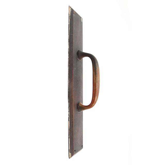 Commercial style door pull made of bronze with a patina finish. The original mounting screws are included. Good condition...