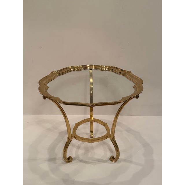 Glamorous pair of cast brass and glass scalloped round end tables having legs that terminate in stylish curves.