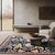 A hand-knotted wool rug, made in India and measuring 8' x 10'. Floral drawing carried across the field inside a...
