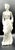 An elegant mid-century classic crafted from pure white glazed porcelain. The figurine depicts a stylish lady in a flowing...