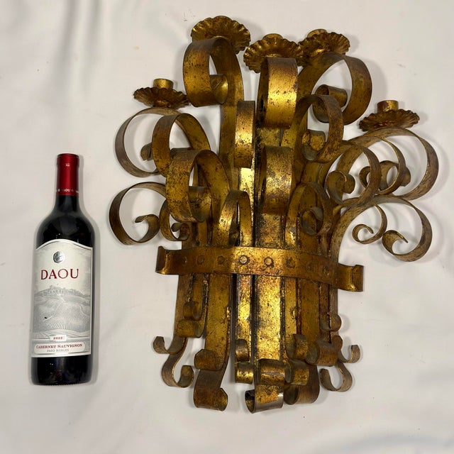 Embrace the ultimate expression of dramatic, maximalist romance with this monumental 1960s Italian Gilt Iron 5-Light...