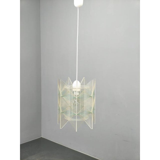 Space age pendant lamp produced in czechoslovakia during the 1970s. The fixture features an intricate sculptural structure...