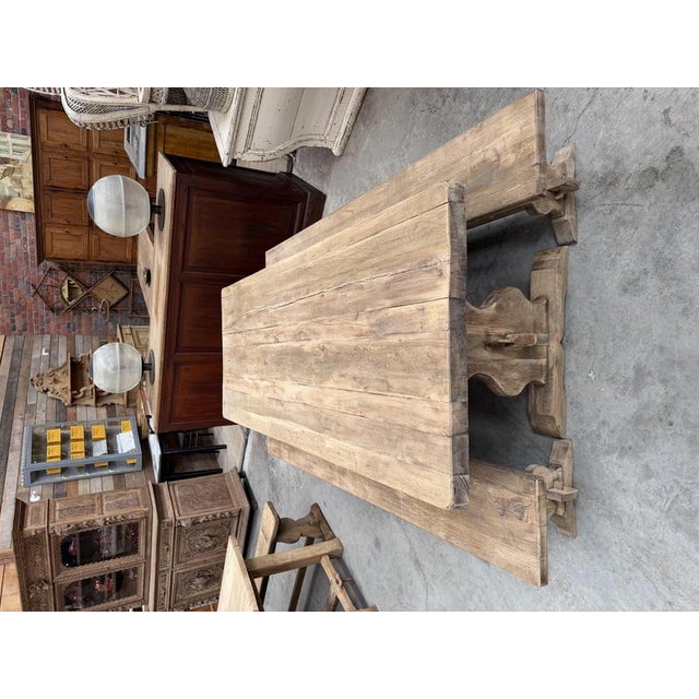 This set, comprising a monastery‑style oak table and its two benches, has been fully restored. The table features a thick...