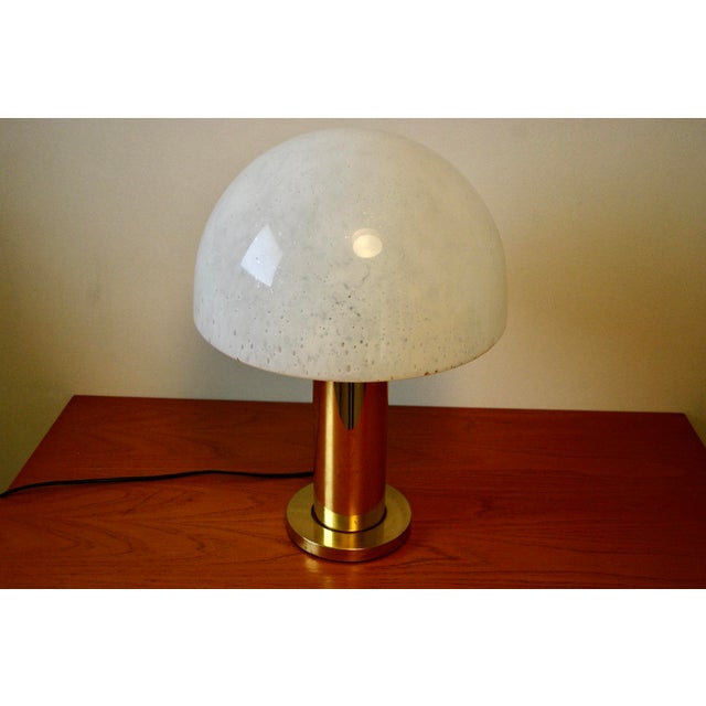 Large 1970s table lamp in gilded brass with a blown glass shade, in good condition. This piece has an attribution mark, I...