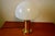 Large 1970s table lamp in gilded brass with a blown glass shade, in good condition. This piece has an attribution mark, I...