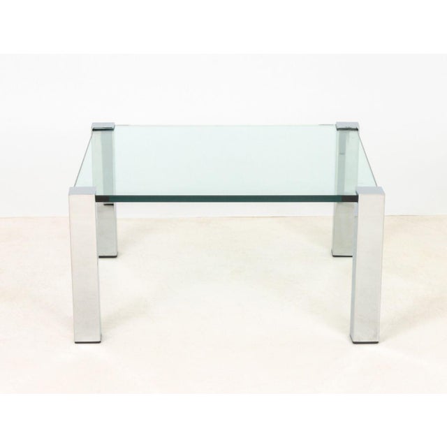 Italian Chrome and Glass Top Coffee Table. 16.25" H x 32.25" W x 32.25" D. Provenance: From the Estate of Gerard Stora,...