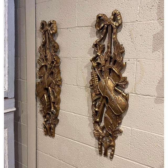 Celebrating music through classical ornamentation, this elegant pair of vintage wall trophies was designed in the Louis...