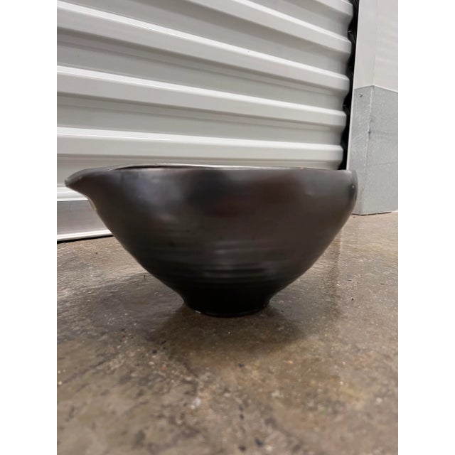 beautiful glazed black bowl, with slight iridescent finish. gives a slight metallic look to it. unusual shape would be...