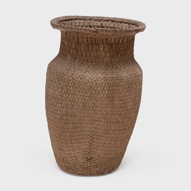 This antique Chinese basket is beautifully woven of river reeds and cord to the sculptural shape of a phoenix-tail vase...
