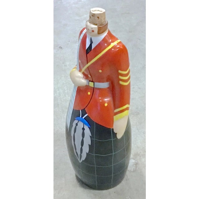 Vintage Robj Scottish soldier decanter dressed in military regalia with kilt, sporran, and jacket. Marked "Robj, Paris,...
